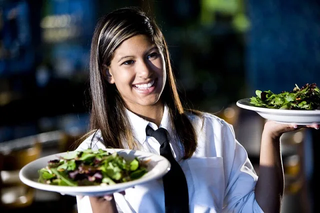 Server presenting a plated dish