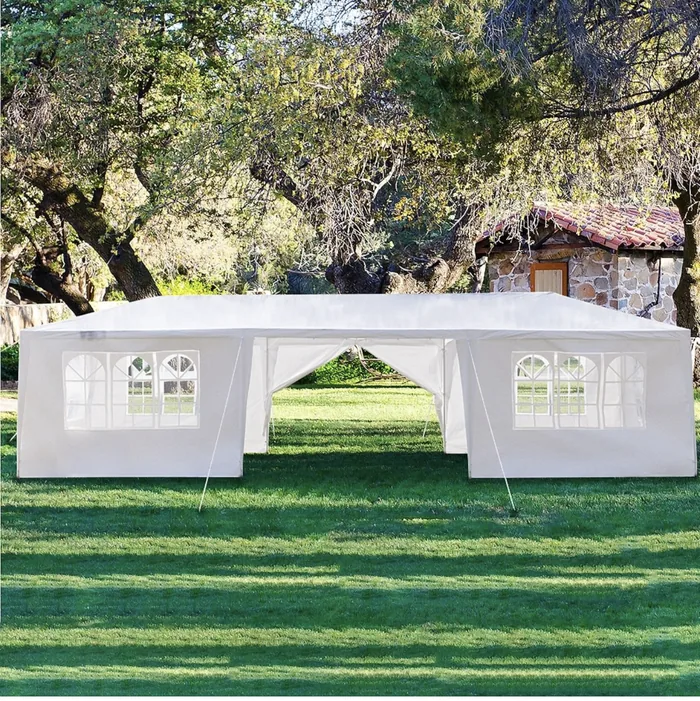 White party tent standing on a lawn