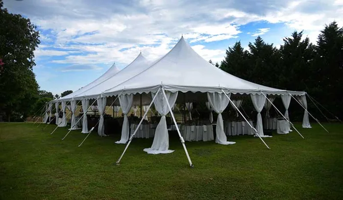Large white frame tent on a lawn