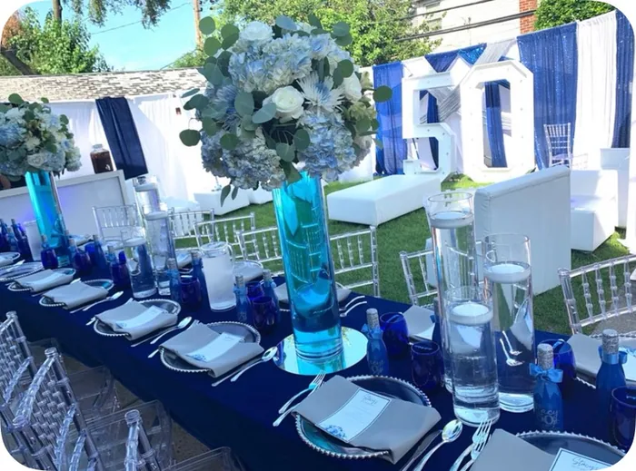 Outdoor table setting with blue decor and florals