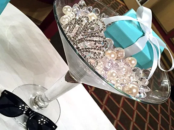 Champagne glass filled with pearls and a tiara
