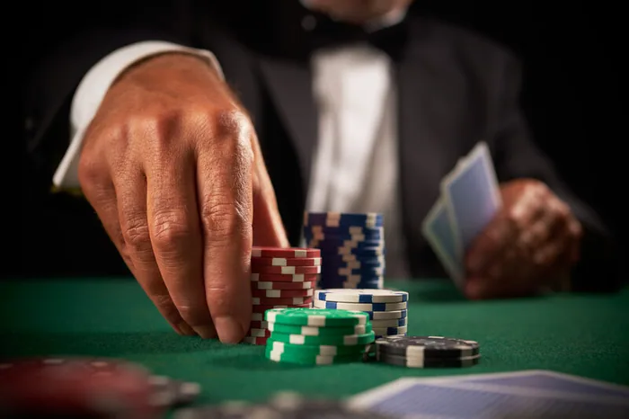 Player placing chips at a blackjack table