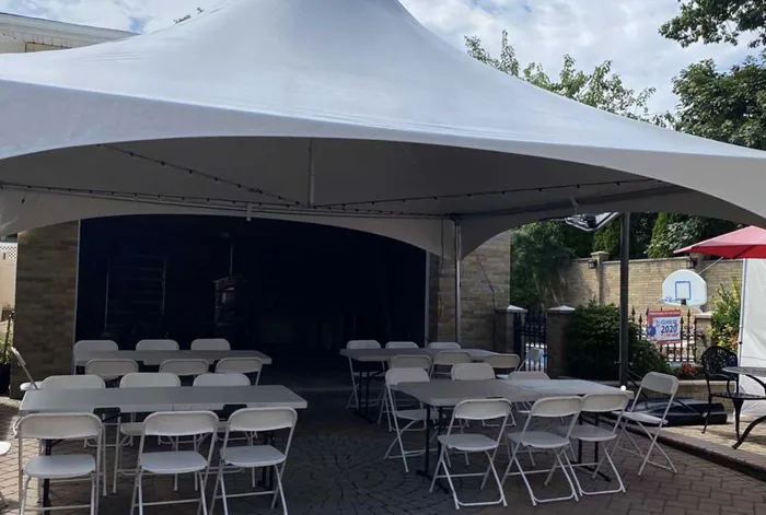 White tent covering a patio set with tables