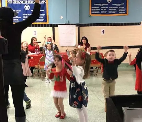Children dancing with light-up props at a party